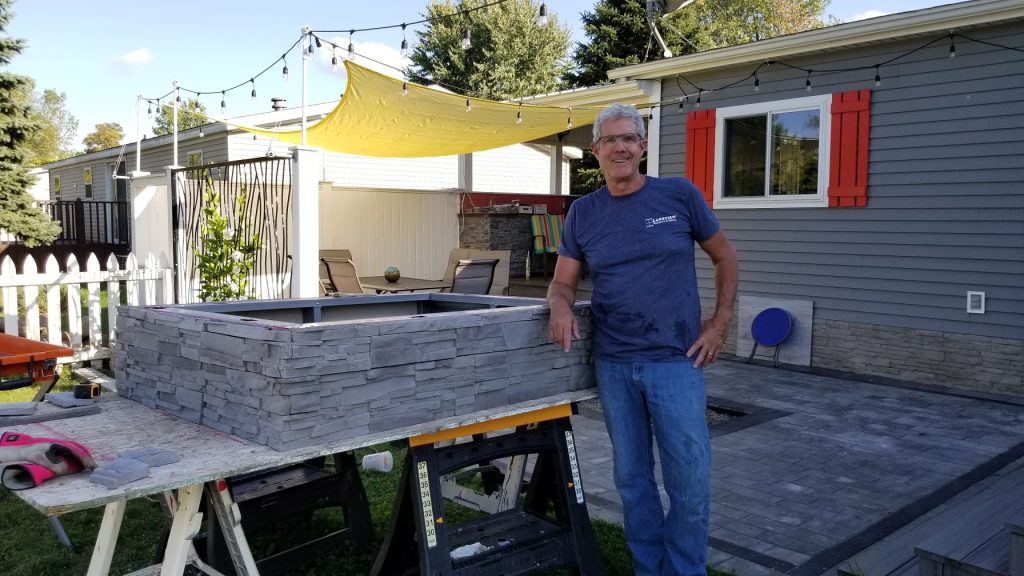 Jeff Jones at a fire table install. The base and concrete table top (not shown) were created in Blue Earth Studio.