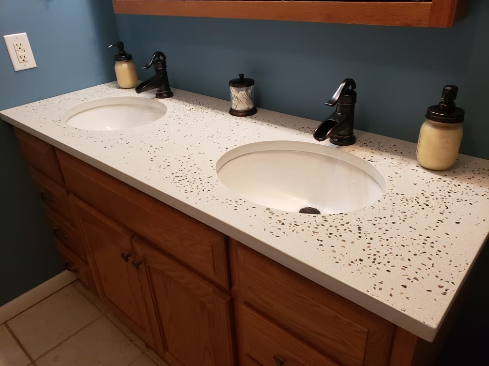 White concrete vanity with dual undermount sinks. This pour features pea stone aggregate for a unique look.