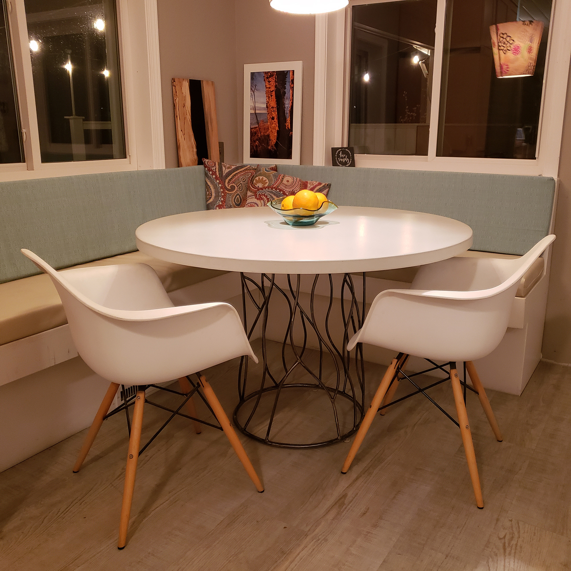 46" round, white concrete table with metal twisted tree trunk base.